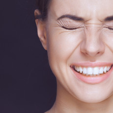 Profilaufnahme einer Frau, die die Augen zusammenkneift